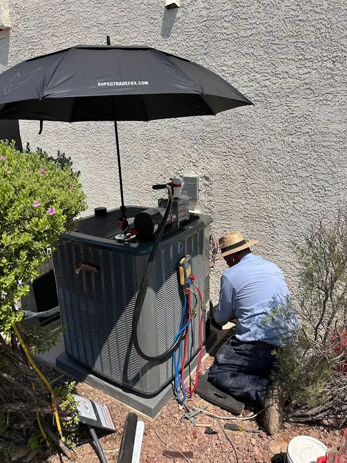 HVAC technician performing outdoor AC maintenance in Hartsville